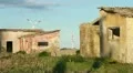 Abandoned house with wind turbine on background HD Footage