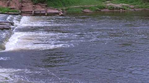 Abandoned hydroelectric power station on river waterfall with streaming current. Stock-Footage 129383752