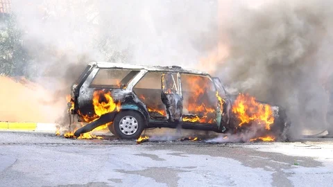An abandoned import car on fire burns. Stock Footage 86574320