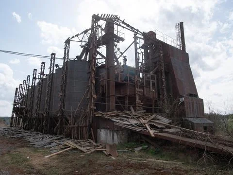 Abandoned Industrial Facility With Decaying Structures and Weathered Materials Stock Photos