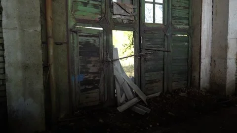 Abandoned Industrial Space with Sunlight Filtering Through Broken Windows Stock Footage 294985531