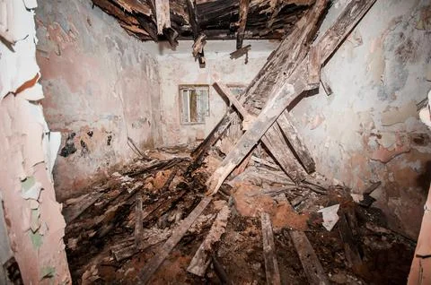 Abandoned Interior of a Deteriorating Structure with Collapsed Ceiling and .. Stock Photos