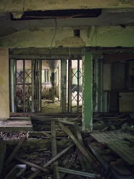 Abandoned interior hall with collapsed flooring and multiple doorways in deca Stock Photos