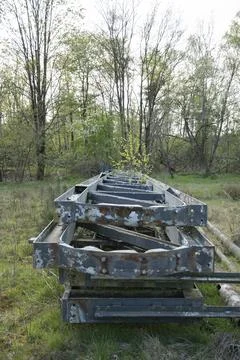 Abandoned large metal structures with peeling paint in the middle of the forest Stock Photos