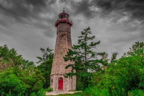 An abandoned lighthouse in a cloudy day Stock Photos