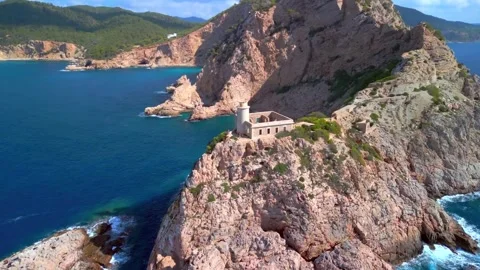 Abandoned lighthouse on a rugged Mediterranean cliff Stock-Footage 341328403