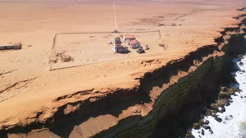 Abandoned lighthouse on sandstone cliffs on Angola coast Stock Footage 310664408