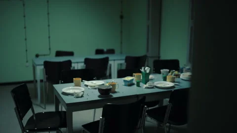 Abandoned messy dining table in an empty institutional room Stock Footage 335492321