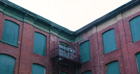 Abandoned mill, boarded up windows, in the rain 動画素材 239290774