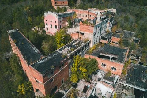 An abandoned mining and processing facility sits in disrepair, with crumbling Stock Photos