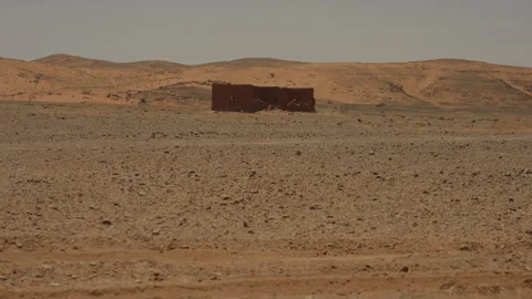 Abandoned Mud Brick Building in Vast Moroccan Desert Landscape Stock Footage 336423722