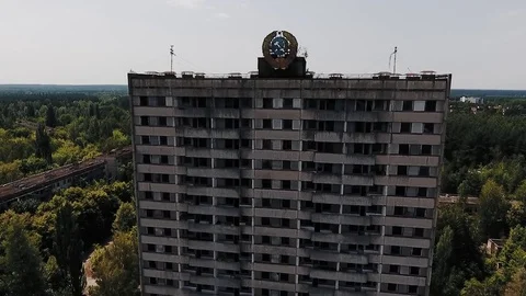 Abandoned multi-storey building with the Soviet coat of arms on the facade in th Stockbeeldmateriaal 72251090