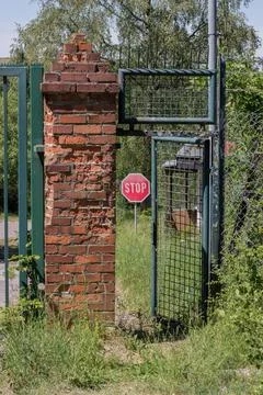 Abandoned object in the forest with an open door with a stop sign in the back Stock Photos