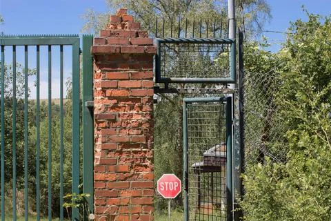 Abandoned object in the forest with an open door, with a stop sign in the bac Stock Photos