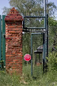 Abandoned object in the forest with an open door, with a stop sign in the bac Stock Photos