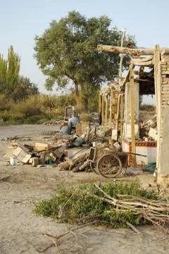 Abandoned objects in front of house, Chinese Xinjiang province Stock Photos