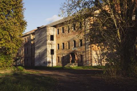 An abandoned, old building with no windows, among autumn, yellow trees Stock Photos