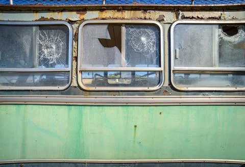 Abandoned old bus side view. Vintage pattern with peeled paint and broken gla Stock Photos
