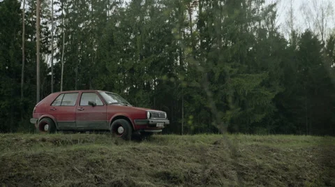 Abandoned old car on the forest road Stock Footage 65311399