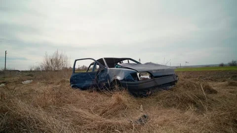 Abandoned Old Rusty Car Forgotten in The Field with dried grass. Stock Footage 296390561