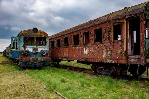 Abandoned old rusty electric multiple unit and passenger car Stock Photos