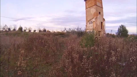 Abandoned  old scary building surrounded by dead flowers during autumn sunset  Stock Footage 103168733