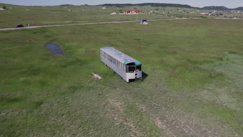 Abandoned Old Train Car in a Field Pan Out and Around 4K Stock Footage 246007499