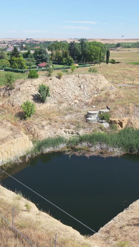 Abandoned open-pit mine filled with water near a Spanish village Vídeos de archivo 340996965