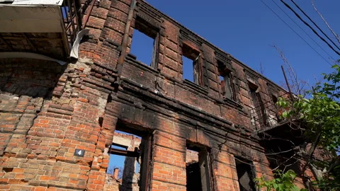 Abandoned partially destroyed brick burned down house in the city Stock Footage 119494845