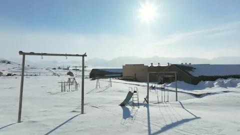 Abandoned Playground Covered in Deep Snow Under Bright Arctic Sun 4k 库存影片 338265456