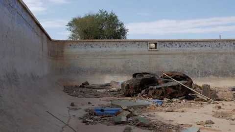 Abandoned pool during drought with old truck tyre's. Stock-Footage 171054747
