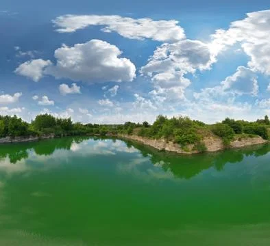 Abandoned quarry in the azure water, open pit mining in Ukraine Stock Photos