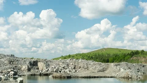 Abandoned quarry. A timelapse of moving clouds in the sky with a mountain top in Stock Footage 199216817