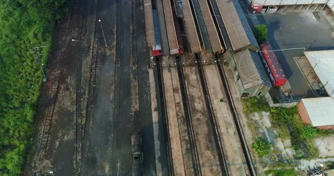 Abandoned rail facility seen from above with rusted train hangars 4K aerial Stock-Footage 85953024