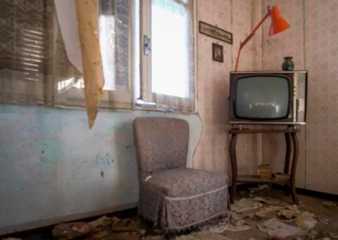 Abandoned room with old television and dust cabinet Stock Photos