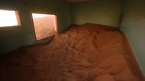 An abandoned room partly filled with red sand in the desert. 스톡 동영상 201102456