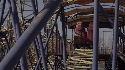 An abandoned, rust-covered roller coaster ride in an abandoned amusement park. Stock Footage 151512099