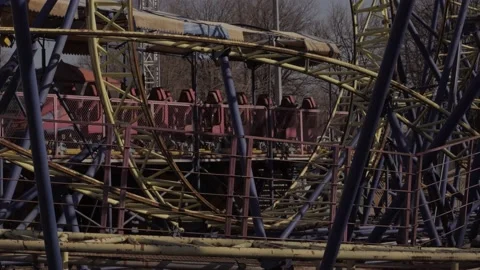 An abandoned, rust-covered roller coaster ride in an abandoned amusement park. Stock Footage 151512184