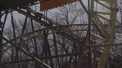 An abandoned, rust-covered roller coaster ride in an abandoned amusement park. Stock Footage 151512249