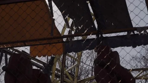 An abandoned, rust-covered roller coaster ride in an abandoned amusement park. Stock Footage 151545158