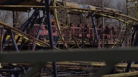 An abandoned, rust-covered roller coaster ride in an abandoned amusement park. Stock Footage 151587142
