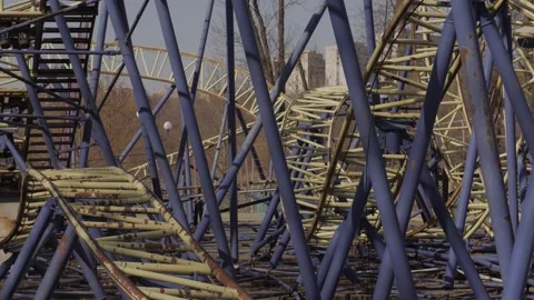 An abandoned, rust-covered roller coaster ride in an abandoned amusement park. Stock Footage 151587211