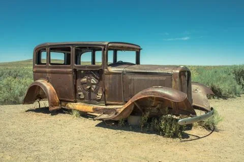 Abandoned Rusted antique car near painted desert on Route 66 Stock Photos