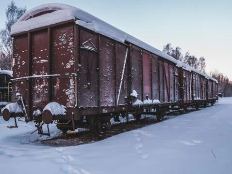 Abandoned rusting train cargo car railway in winter Stock Photos