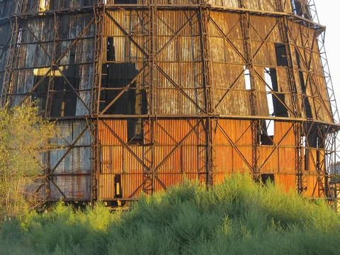 An abandoned, rusty industrial structure with multiple levels, exposed to e.. Stock Photos