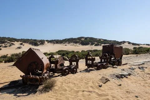 Abandoned rusty mining carts on a desert landscape Stock Photos