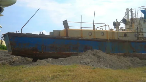 Abandoned rusty ship standing on the shore of the Black Sea Stock Footage 94136651