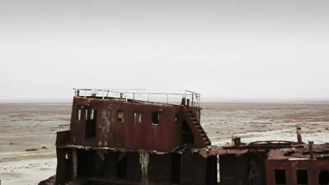 Abandoned rusty shipwreck sinking into the Aral Sea desert Video stock 333149734