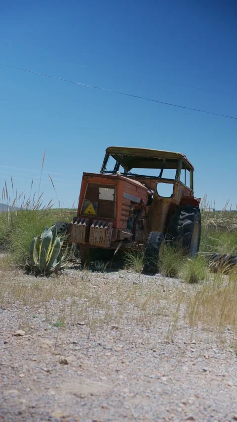 Abandoned rusty vintage tractor decaying in rural farmland Stock Footage 337901131