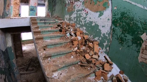 Abandoned school between the first and second floors descent down corridor Stock Footage 87179050